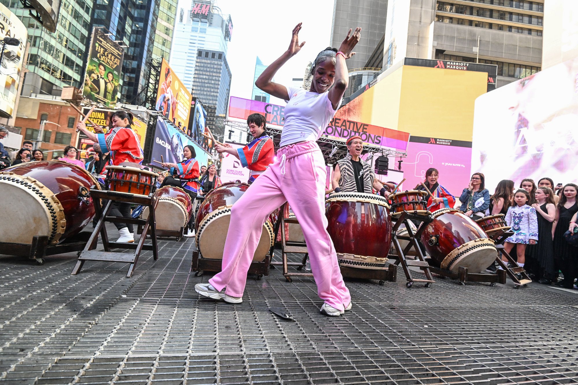 Woman dancing in front of a band performing.